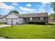 Well-maintained ranch-style home with brick detail, shutters, and manicured lawn at 905 Congressional Way, Shelbyville, IN 46176