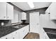 Kitchen features updated black countertops, white cabinets and vinyl flooring at 905 Congressional Way, Shelbyville, IN 46176