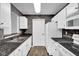 Kitchen featuring updated black countertops, white cabinets and vinyl flooring at 905 Congressional Way, Shelbyville, IN 46176
