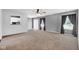 Open living room featuring carpet floors and natural light with grey walls and modern curtains at 905 Congressional Way, Shelbyville, IN 46176