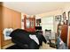 Bedroom featuring a comfortable bed, eclectic decor, and a well-lit window at 9098 W 1050 N, Elwood, IN 46036