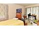 Bedroom with a wooden bed frame, chest of drawers, and tv, filled with natural light from a window at 9098 W 1050 N, Elwood, IN 46036