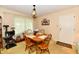 Cozy dining area featuring a wooden table with chairs, a decorative light fixture, and ample natural light at 9098 W 1050 N, Elwood, IN 46036