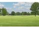 Scenic view of a lush green golf course with mature trees and blue skies at 9098 W 1050 N, Elwood, IN 46036
