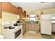 Functional kitchen with white appliances, ample counter space, and natural light from a window at 9098 W 1050 N, Elwood, IN 46036