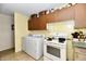 A tidy laundry room with washer, dryer, and utility sink, offering convenience and practicality at 9098 W 1050 N, Elwood, IN 46036