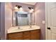Bathroom featuring a double sink vanity, decorative lighting and a shower over tub setup at 924 S B St, Elwood, IN 46036