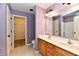 Well-lit bathroom featuring a double sink vanity, toilet, and walk in closet, complete with a tub and shower combo at 924 S B St, Elwood, IN 46036