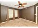 Bedroom featuring carpeted floors, neutral walls, a ceiling fan and windows at 924 S B St, Elwood, IN 46036