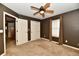 Bedroom featuring carpeted floors, neutral walls, a ceiling fan, closets and windows at 924 S B St, Elwood, IN 46036