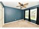 This cozy bedroom with neutral carpet and a ceiling fan at 924 S B St, Elwood, IN 46036