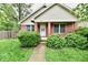 Charming brick home featuring a well-maintained front yard with mature trees and lush landscaping at 924 S B St, Elwood, IN 46036