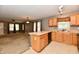 Spacious kitchen offers wooden cabinets, stainless steel sink, and an open view of the living room at 924 S B St, Elwood, IN 46036
