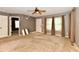 Inviting living room features neutral walls, carpet, a ceiling fan, and natural light from the large window at 924 S B St, Elwood, IN 46036
