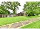 Spacious backyard with green lawn and wood fence bordering the property at 924 S B St, Elwood, IN 46036
