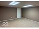 Clean basement with neutral carpet, painted walls, and updated lighting, perfect for additional living space at 9650 Copley Dr, Carmel, IN 46290