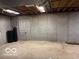 Unfinished basement with exposed concrete walls and ceiling, offering a blank canvas for customization at 9650 Copley Dr, Carmel, IN 46290