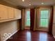 Bedroom features hardwood floors, two windows, and built in storage at 9650 Copley Dr, Carmel, IN 46290