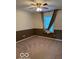 Empty bedroom with ceiling fan, neutral carpet and large window at 9650 Copley Dr, Carmel, IN 46290