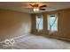 Spacious bedroom with neutral walls, ceiling fan, and large windows at 9650 Copley Dr, Carmel, IN 46290