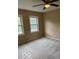 Bedroom features neutral walls, carpet, and two windows at 9650 Copley Dr, Carmel, IN 46290