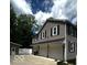 Charming two-story home with grey siding, white trim, and attached three-car garage, creating an inviting curb appeal at 9650 Copley Dr, Carmel, IN 46290