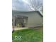View of the exterior with a covered porch, featuring a playhouse and adjacent lawn at 9650 Copley Dr, Carmel, IN 46290
