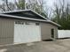 Spacious exterior garage featuring a white door and modern design, perfect for storage and vehicle parking at 9650 Copley Dr, Carmel, IN 46290