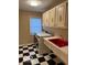 Functional laundry room features a red utility sink and white cabinets, with a washer and dryer for convenience at 9650 Copley Dr, Carmel, IN 46290