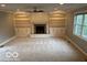 Spacious living room features a fireplace, built-in bookshelves, and large windows at 9650 Copley Dr, Carmel, IN 46290