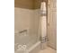 Bathroom features a shower with white tile surround and a framed glass door, creating a clean and modern look at 9650 Copley Dr, Carmel, IN 46290