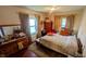 Comfortable bedroom with hardwood floors, curtains, and window offering lots of light at 100 N 6Th Ave, Beech Grove, IN 46107