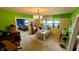 Bright dining room with bold green walls, large built-ins, and classic chandelier at 100 N 6Th Ave, Beech Grove, IN 46107