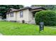 View of the side of a lovely home with a well-kept lawn and professional real estate signage at 100 N 6Th Ave, Beech Grove, IN 46107