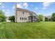 Well-maintained backyard and lawn displaying rear home elevation with screened-in porch at 1029 Bridgeport Dr, Westfield, IN 46074
