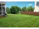 Spacious backyard featuring lush green lawn, privacy fencing, and mature trees at 1029 Bridgeport Dr, Westfield, IN 46074