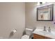 Well-lit half bathroom featuring a modern vanity with a framed mirror and white toilet at 1029 Bridgeport Dr, Westfield, IN 46074