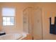 Bathroom with a glass shower and soaking tub beneath a bright window at 1029 Bridgeport Dr, Westfield, IN 46074