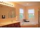Bathroom with double sinks, large tub, and window provides lots of natural light at 1029 Bridgeport Dr, Westfield, IN 46074