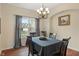 Formal dining room with elegant chandelier, hardwood floors, and a view of the backyard at 1029 Bridgeport Dr, Westfield, IN 46074