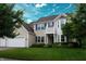 Charming two-story home with blue shutters, well-maintained lawn, and mature trees at 1029 Bridgeport Dr, Westfield, IN 46074