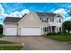 Two-story home featuring a three-car garage, blue shutters, and a small balcony with white columns at 1029 Bridgeport Dr, Westfield, IN 46074