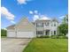 Charming two-story home with a manicured lawn, three-car garage, and lovely curb appeal at 1029 Bridgeport Dr, Westfield, IN 46074