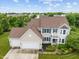 Aerial view showcasing the two-story home with three-car garage and manicured landscaping at 1029 Bridgeport Dr, Westfield, IN 46074