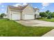 Well-maintained home with a three-car garage, lush green lawn and mature landscaping at 1029 Bridgeport Dr, Westfield, IN 46074