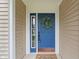 Inviting blue front door with a decorative wreath, side window, and a 'Welcome' mat at 1029 Bridgeport Dr, Westfield, IN 46074