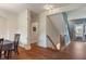 Hallway featuring hardwood floors, staircase with wooden railing, and access to other rooms at 1029 Bridgeport Dr, Westfield, IN 46074