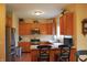 Kitchen with wooden cabinets, stainless steel appliances, and a breakfast bar with seating at 1029 Bridgeport Dr, Westfield, IN 46074