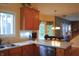 Kitchen with wooden cabinets, white countertops and an opening into the dining room and staircase at 1029 Bridgeport Dr, Westfield, IN 46074