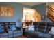 Comfortable living room with reclining chairs and an opening into the dining room and staircase at 1029 Bridgeport Dr, Westfield, IN 46074